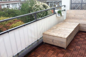 Zeilmaker aan het werk aan een balkondoek